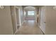 Hallway featuring neutral paint, tile flooring, and archways that lead to various rooms of the house at 11341 Durham St, Parrish, FL 34219