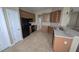 Functional kitchen equipped with stainless steel appliances, wooden cabinetry, and tile flooring at 11341 Durham St, Parrish, FL 34219