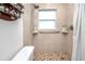 Tiled walk-in shower with a window and safety bar, designed for comfort and accessibility at 12400 Park Blvd # 417, Seminole, FL 33772