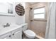 Bright bathroom with a tiled shower, modern fixtures, and a convenient vanity area at 12400 Park Blvd # 417, Seminole, FL 33772
