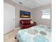Bedroom with a floral bedspread, a comfortable sitting area, and natural light from the window at 12400 Park Blvd # 417, Seminole, FL 33772