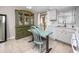 Kitchen and dining area features vintage hutch, neutral cabinets, and tile floors at 12400 Park Blvd # 417, Seminole, FL 33772