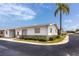 Charming single-story home with a manicured lawn and a beautiful palm tree in a sunny neighborhood at 12400 Park Blvd # 417, Seminole, FL 33772