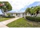 Charming single-story home with lush landscaping, a curved walkway, and a freshly painted exterior at 12400 Park Blvd # 417, Seminole, FL 33772