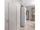 Hallway with built-in cabinets and a refrigerator, offering plenty of storage space at 12400 Park Blvd # 417, Seminole, FL 33772