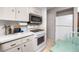 Bright kitchen featuring white cabinets, modern appliances, and ample counter space for cooking at 12400 Park Blvd # 417, Seminole, FL 33772