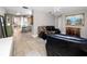 Open living room with tile flooring and a dining area adjacent to kitchen at 12400 Park Blvd # 417, Seminole, FL 33772