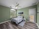 Bedroom with light green walls, ceiling fan, and window with blinds at 12413 Woodlands Cir, Dade City, FL 33525