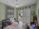 Workout room with weights, ceiling fan and slider to screened patio at 12413 Woodlands Cir, Dade City, FL 33525