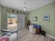 Workout room with desk, ceiling fan and slider to screened patio at 12413 Woodlands Cir, Dade City, FL 33525