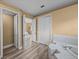 Hallway between the main bathroom, the bedroom, and a closet at 12413 Woodlands Cir, Dade City, FL 33525