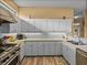 Well-lit kitchen featuring modern appliances, neutral countertops, and ample cabinet storage space at 12413 Woodlands Cir, Dade City, FL 33525