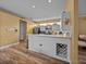 Open kitchen boasts modern appliances, eat-in bar, and charming wine rack features at 12413 Woodlands Cir, Dade City, FL 33525