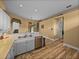 Bright kitchen with double sink, stainless steel dishwasher, wood-style flooring, and charming accents at 12413 Woodlands Cir, Dade City, FL 33525
