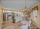 Bright kitchen with white cabinetry, stainless steel appliances, and a breakfast bar connecting to the living space at 12413 Woodlands Cir, Dade City, FL 33525