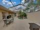 The screened lanai boasts a tranquil spa, outdoor seating, and serene ambiance at 12413 Woodlands Cir, Dade City, FL 33525