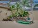 This screened lanai features an inviting spa surrounded by rock landscaping and lush vegetation at 12413 Woodlands Cir, Dade City, FL 33525