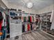 Spacious walk-in closet with custom shelving, drawers, and a chandelier at 12413 Woodlands Cir, Dade City, FL 33525