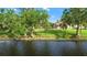 Expansive backyard with mature trees leading to waterfront at 1313 Oxbridge Dr, Lutz, FL 33549