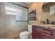 Bathroom with a glass shower door, vanity with countertop, and an ornate wall shelf at 1313 Oxbridge Dr, Lutz, FL 33549