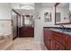 Spacious bathroom with double vanities, tiled floors, step up jacuzzi tub and glass-enclosed shower at 1313 Oxbridge Dr, Lutz, FL 33549
