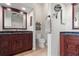 This bathroom has double vanities with granite counters, tile flooring and modern fixtures at 1313 Oxbridge Dr, Lutz, FL 33549