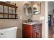 Bathroom featuring a vanity with countertop, a round mirror, and decorative wall shelves at 1313 Oxbridge Dr, Lutz, FL 33549