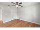 Bedroom featuring hardwood floors, a ceiling fan with light and closet at 1313 Oxbridge Dr, Lutz, FL 33549