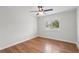 Bedroom with hardwood floors, a ceiling fan with light and window with shutters at 1313 Oxbridge Dr, Lutz, FL 33549