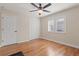Bedroom with hardwood floors, window with shutters, closet and ceiling fan with light at 1313 Oxbridge Dr, Lutz, FL 33549