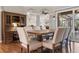 Open dining area featuring hardwood floors, wainscoting, and views into the kitchen and living spaces at 1313 Oxbridge Dr, Lutz, FL 33549