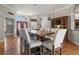 Elegant dining room featuring hardwood floors, wainscoting, and a large table with seating for six at 1313 Oxbridge Dr, Lutz, FL 33549