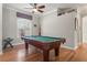 Recreation room featuring hardwood floors, a billiard table, and plenty of natural light at 1313 Oxbridge Dr, Lutz, FL 33549