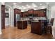 Spacious kitchen with wooden cabinets, stainless steel appliances, and a center island with granite countertops at 1313 Oxbridge Dr, Lutz, FL 33549