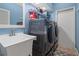 Laundry room with washer, dryer, sink, and overhead shelving at 1313 Oxbridge Dr, Lutz, FL 33549