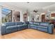 Expansive living room with hardwood floors, a fireplace, and views of the outdoor area at 1313 Oxbridge Dr, Lutz, FL 33549