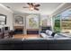 Bright living room with a fireplace, large windows, and a view of the pool and backyard at 1313 Oxbridge Dr, Lutz, FL 33549