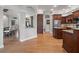 Open-concept living area with hardwood floors, neutral paint, and seamless transition to the kitchen at 1313 Oxbridge Dr, Lutz, FL 33549