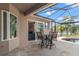 Screened-in patio with outdoor seating overlooking the pool, backyard, and lake views at 1313 Oxbridge Dr, Lutz, FL 33549