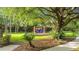 Community playground featuring swings, slide, picnic tables and shade trees provides outdoor recreational opportunity at 1313 Oxbridge Dr, Lutz, FL 33549