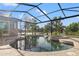 Gorgeous pool area with a spa, screened enclosure, and serene lake views at 1313 Oxbridge Dr, Lutz, FL 33549