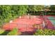 Aerial view of community sports courts featuring basketball, pickle ball and tennis courts with fencing and lighting at 1313 Oxbridge Dr, Lutz, FL 33549