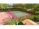 Aerial view of community tennis court, basketball court and pickle ball court surrounded by mature trees at 1313 Oxbridge Dr, Lutz, FL 33549