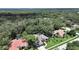 Aerial shot of a well-kept home with a screened pool nestled in a neighborhood surrounded by lush greenery at 15024 Eaglepark Pl, Lithia, FL 33547