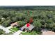 Aerial shot of a private home in a wooded community featuring a screened pool and backyard at 15024 Eaglepark Pl, Lithia, FL 33547