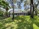 Backyard view of a screen enclosed pool featuring a beautifully landscaped backyard at 15024 Eaglepark Pl, Lithia, FL 33547