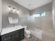 Bathroom featuring gray walls, modern vanity, and tiled shower/tub combo at 15024 Eaglepark Pl, Lithia, FL 33547
