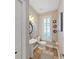 This powder room has a pedestal sink, hardwood floors, shuttered window, and modern decor at 15024 Eaglepark Pl, Lithia, FL 33547