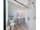 Bathroom features a glass shower, wood-look vanity and window with privacy screen at 15024 Eaglepark Pl, Lithia, FL 33547