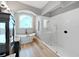 This bathroom features a soaking tub, a walk in shower, dual dark vanities, and hardwood floors at 15024 Eaglepark Pl, Lithia, FL 33547